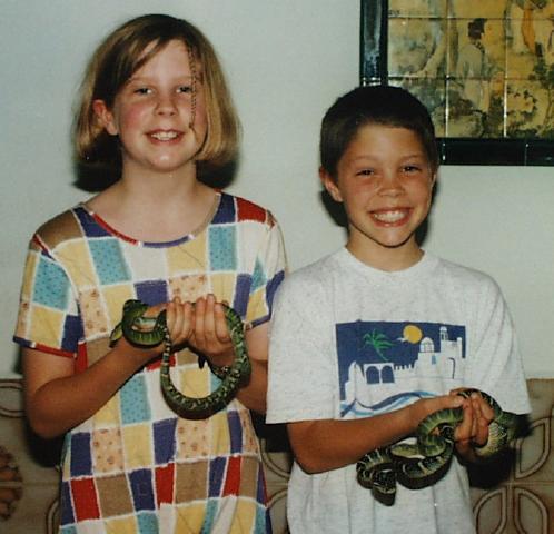 Children holding venomous Wagler's Vipers at Snake Temple.